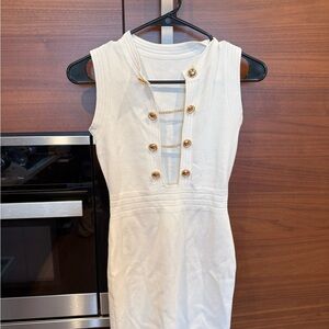 White sleeveless knit mini dress with gold button detail